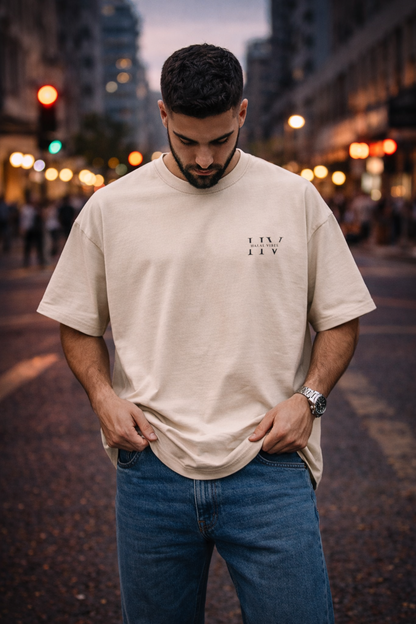 Front view of sand-beige streetwear tee featuring a tonal Halal Vibes HV monogram on the chest lifestyle image.