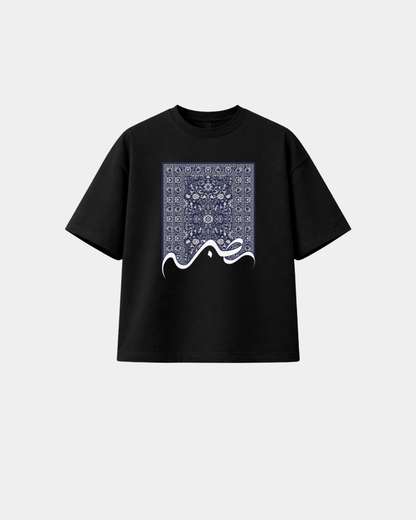Black heavyweight boxy T-shirt featuring Sabr Arabic calligraphy and blue prayer-rug-inspired artwork.