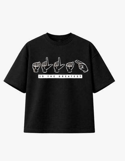 Front view of a black 300gsm heavyweight boxy fit t-shirt featuring white ASL hand signals for Allah and the text IS THE GREATEST.