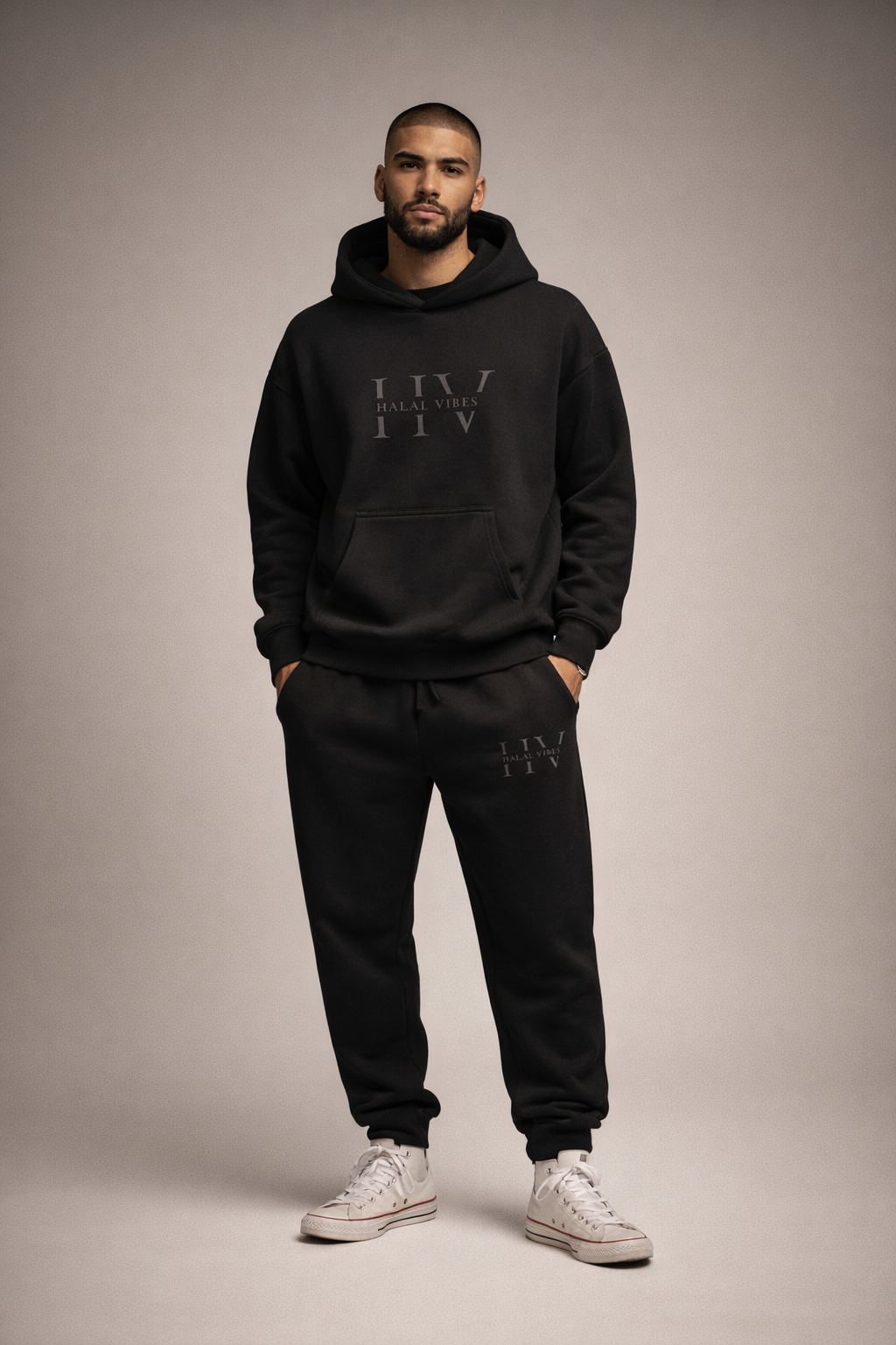 Model in a studio setting wearing the HV Stealth Edition Hoodie and matching Joggers.