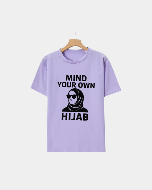 Lavender 100% cotton t-shirt featuring the text Mind Your Own Hijab with a woman in a hijab and sunglasses.