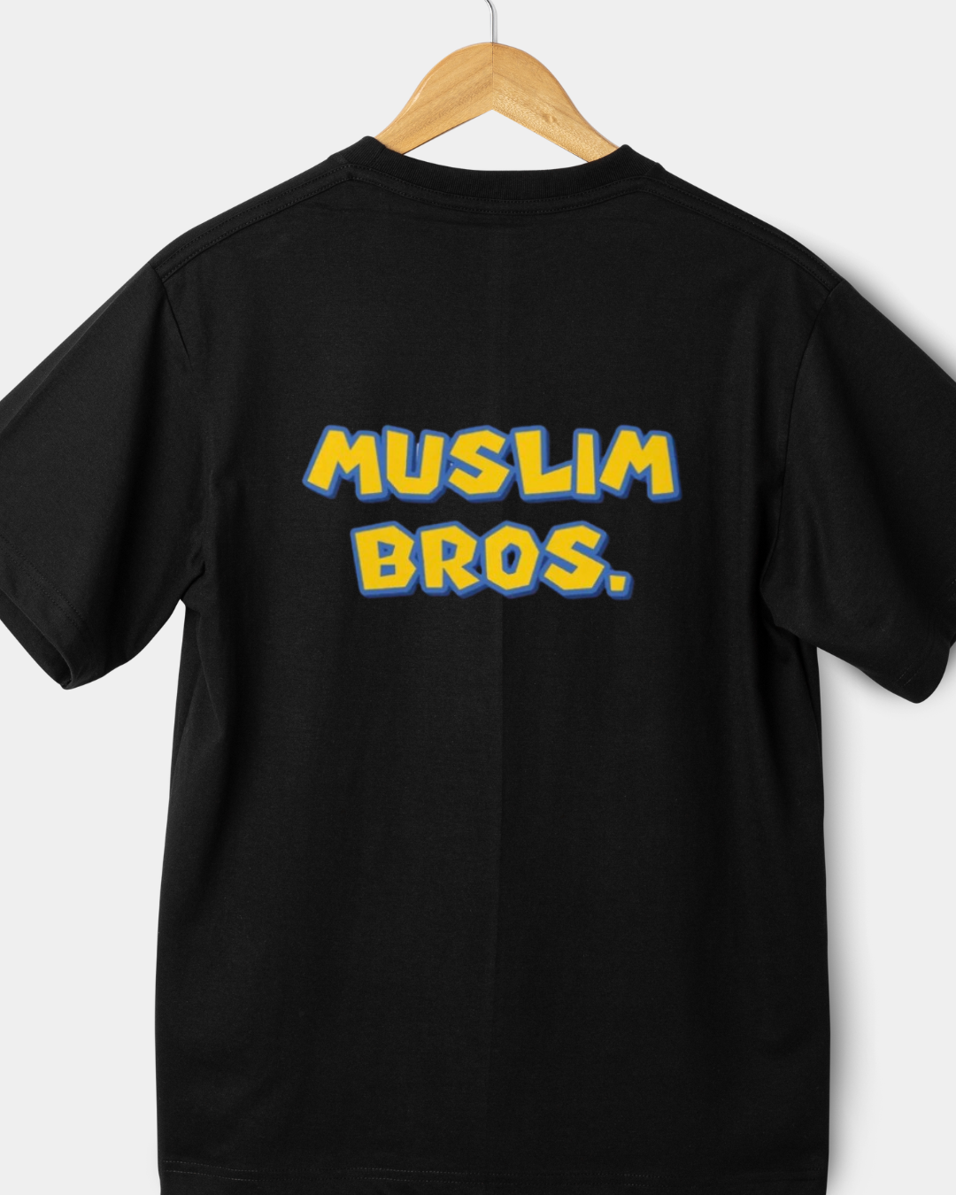 black 180gsm regular fit t-shirt with "MUSLIM BROS." in yellow and blue gaming-style typography.