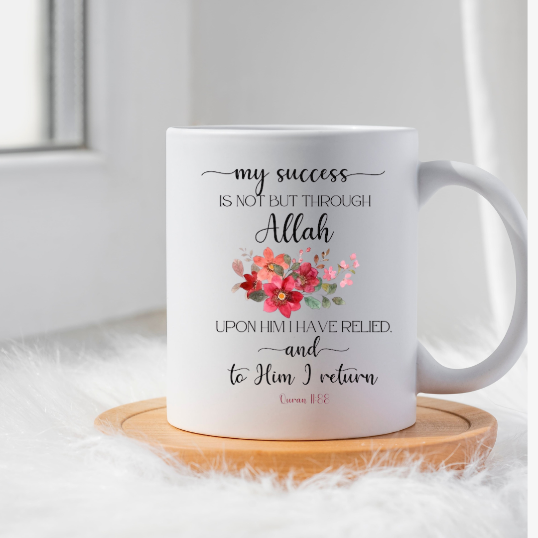 White ceramic mug with red floral illustration and Quranic verse 11:88 about success.