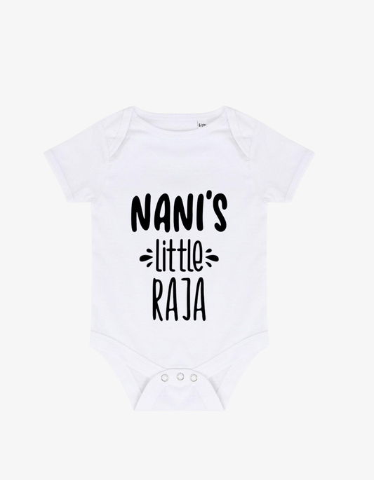 White baby grow with bold black typography saying NANI'S little RAJA.