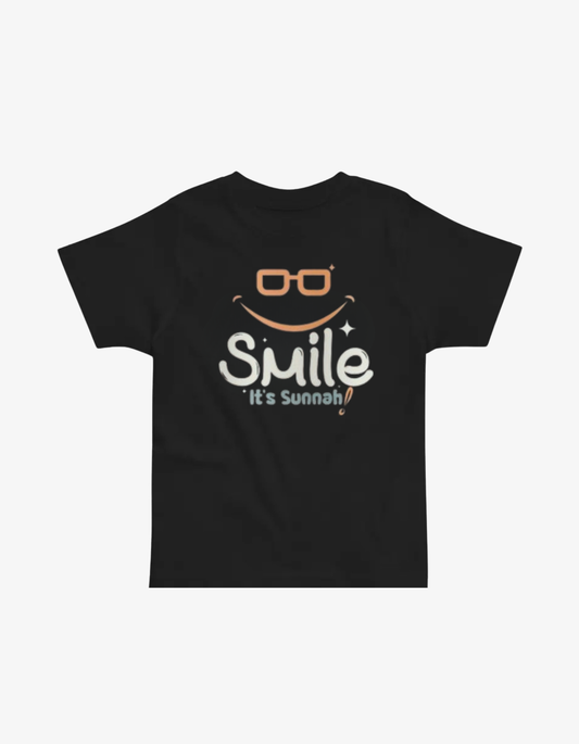 Black kids t-shirt with orange glasses and a smile graphic saying Smile It's Sunnah.