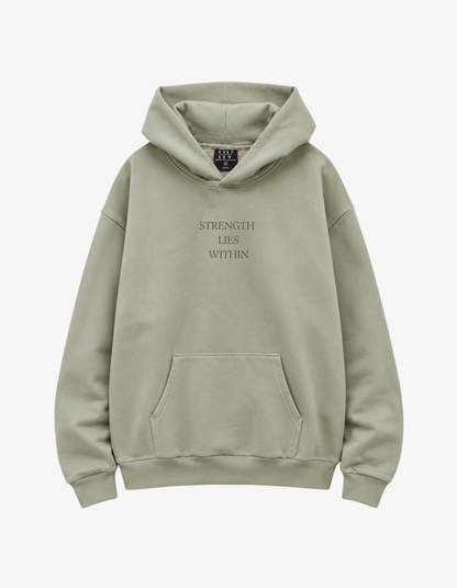 Front view showing a sage green hoodie with text Strength Lies Within.