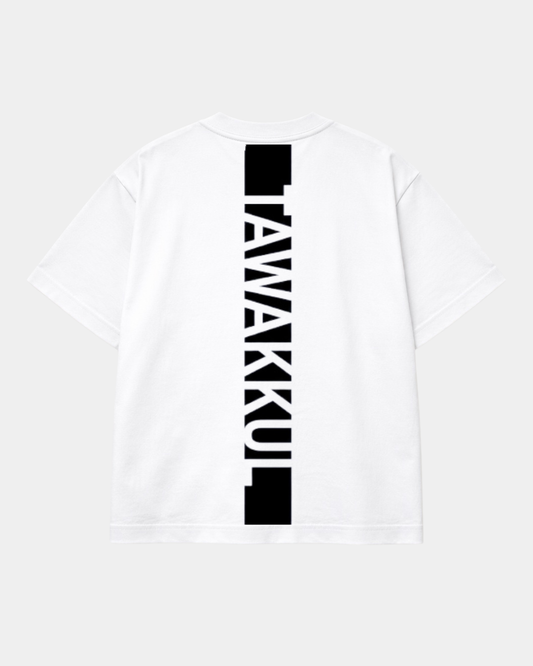 Back view of a white heavyweight t-shirt with a bold black vertical stripe containing the word TAWAKKUL in white text.